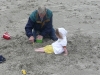 Grandpa buries CareBear in the sand.