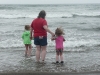 Cousin H, Amy and CareBear contemplate the waves.