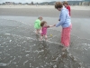 Cousin H and CareBear in the surf with Auntie T and Grandma.