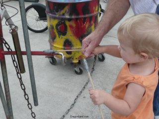 LiliBee bangs a drum.